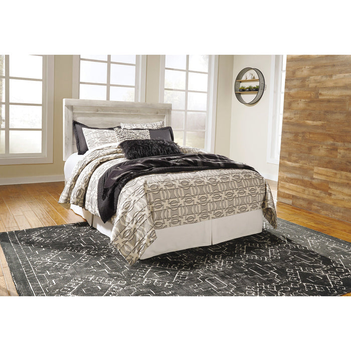 A room setting featuring Bellaby Whitewash Queen Panel Headboard