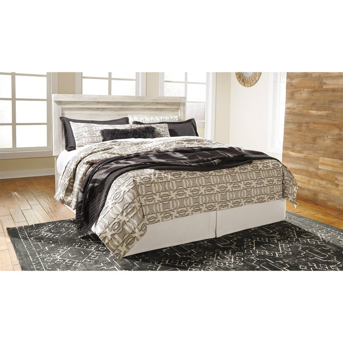 A room setting featuring Bellaby Whitewash King Panel Headboard