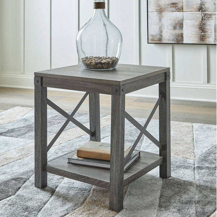 A room setting featuring Freedan Grayish Brown End Table