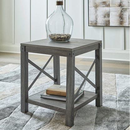 A room setting featuring Freedan Grayish Brown End Table